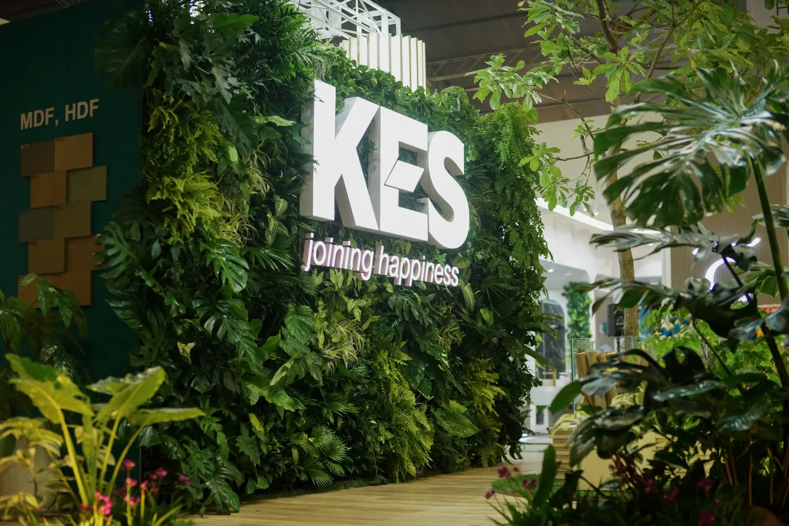 Close view of live plants arranged around the KES booth logo