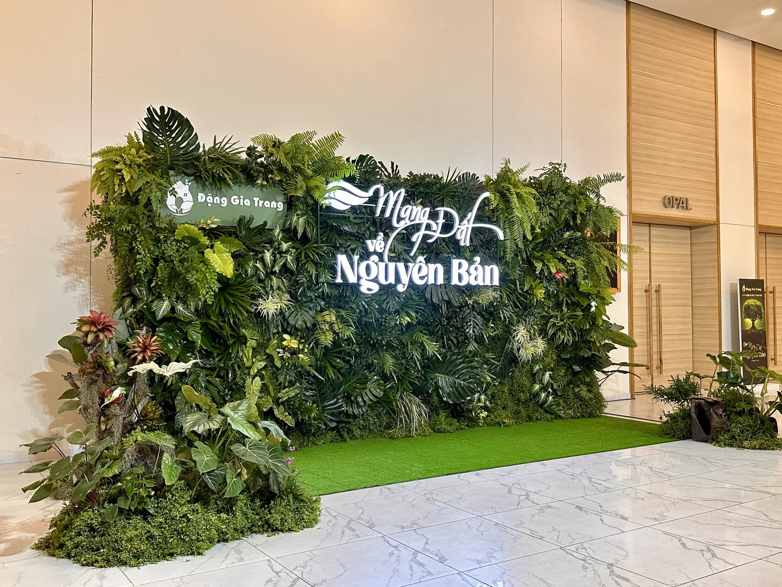 Close view of tropical foliage across the Dang Gia Trang event backdrop