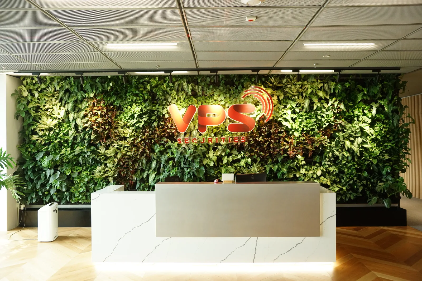 Office green wall with the VPS logo held clear of the foliage